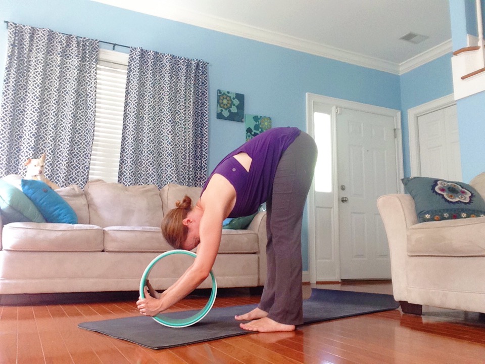 5 Gentle Yoga Poses You Can Practice With a Yoga Wheel | Supported Forward Bend - Uttanasana with Yoga Wheel | YogiWheel Product Review | SpoiledYogi.com